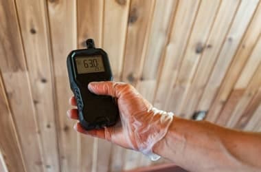 Damp specialist taking a moisture reading on a London wall